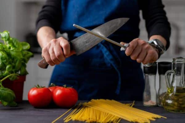 Positioning the Knife and Rod To Sharpen A Kitchen Knife With Rod